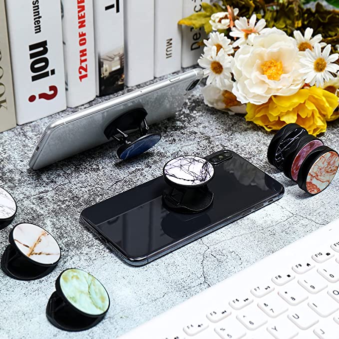 "Securely and Stylishly Hold Your Phone (Each Sold Separately): Colorful Collapsible Phone Holders with a Marble Design for Ultimate Comfort and Stability!"